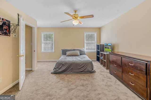 bedroom with multiple windows and light colored carpet