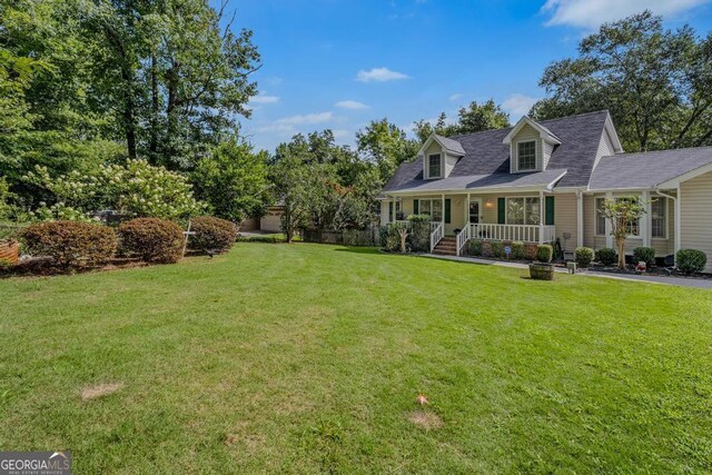 view of front facade featuring a front lawn and covered porch