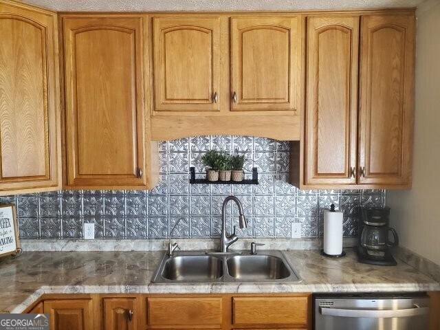 kitchen with dishwasher, sink, and decorative backsplash