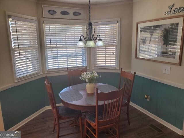 dining room with a notable chandelier and dark hardwood / wood-style floors