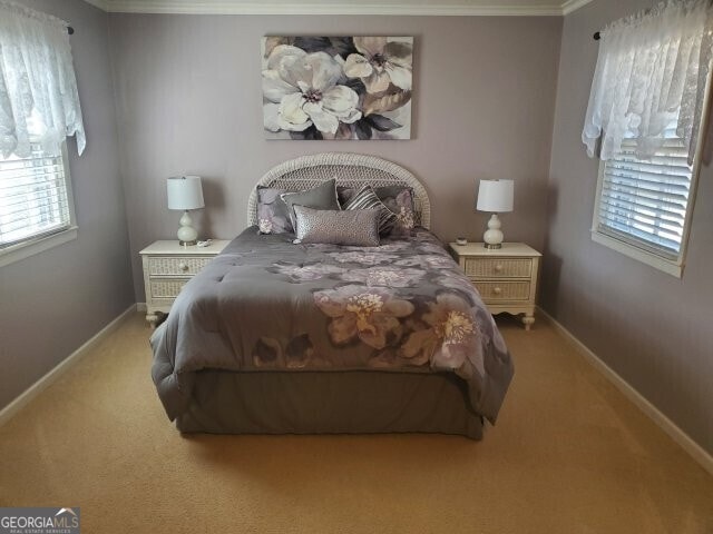 carpeted bedroom featuring ornamental molding