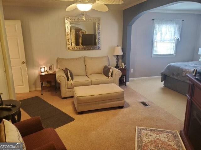 bedroom featuring ceiling fan and light carpet