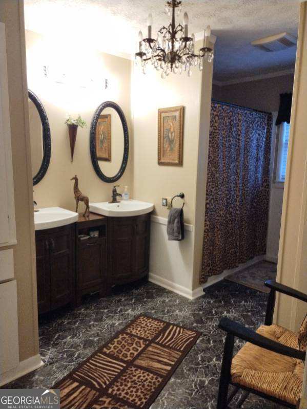 bathroom with vanity, a shower with curtain, and an inviting chandelier