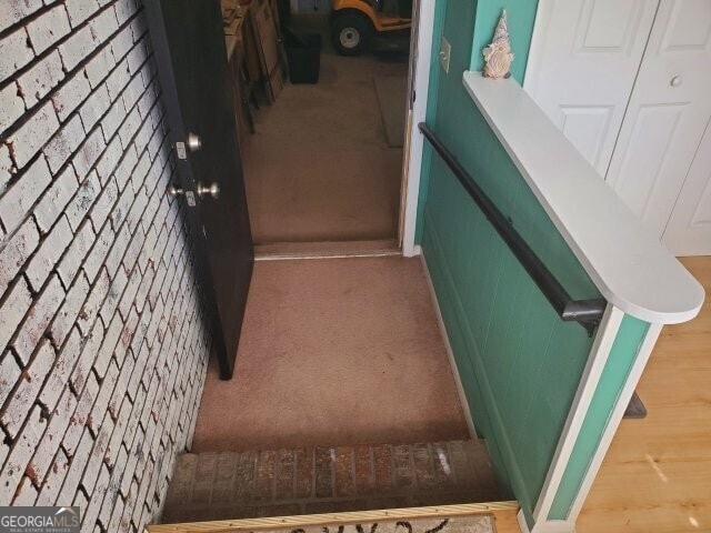 stairway featuring carpet floors