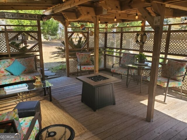 deck featuring an outdoor fire pit