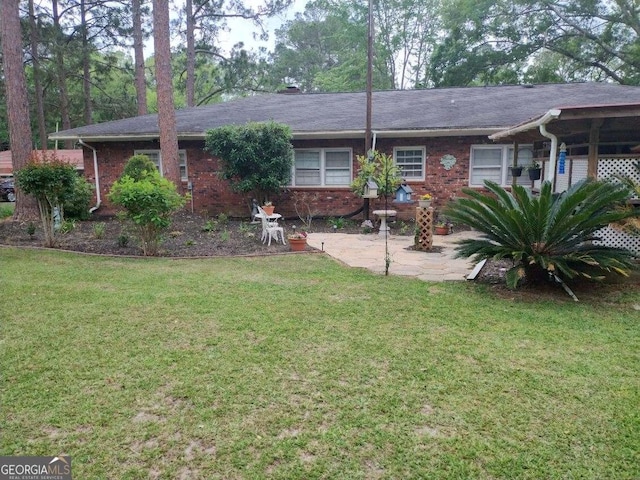 back of property featuring a patio and a lawn