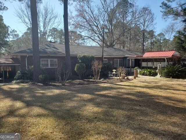 back of house with a yard