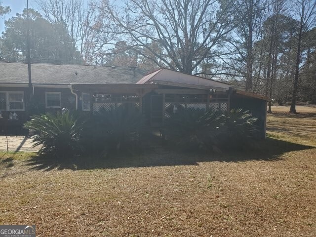 view of side of home featuring a lawn