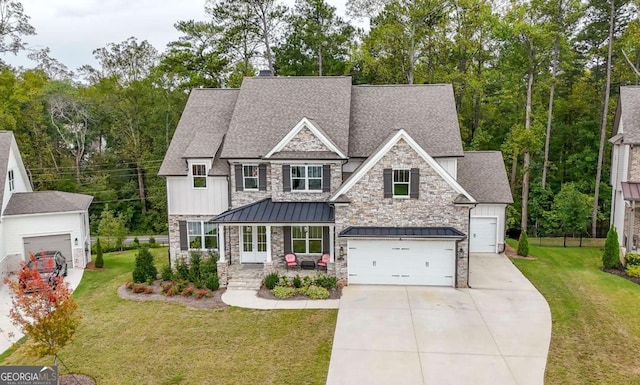 craftsman inspired home with a garage and a front yard