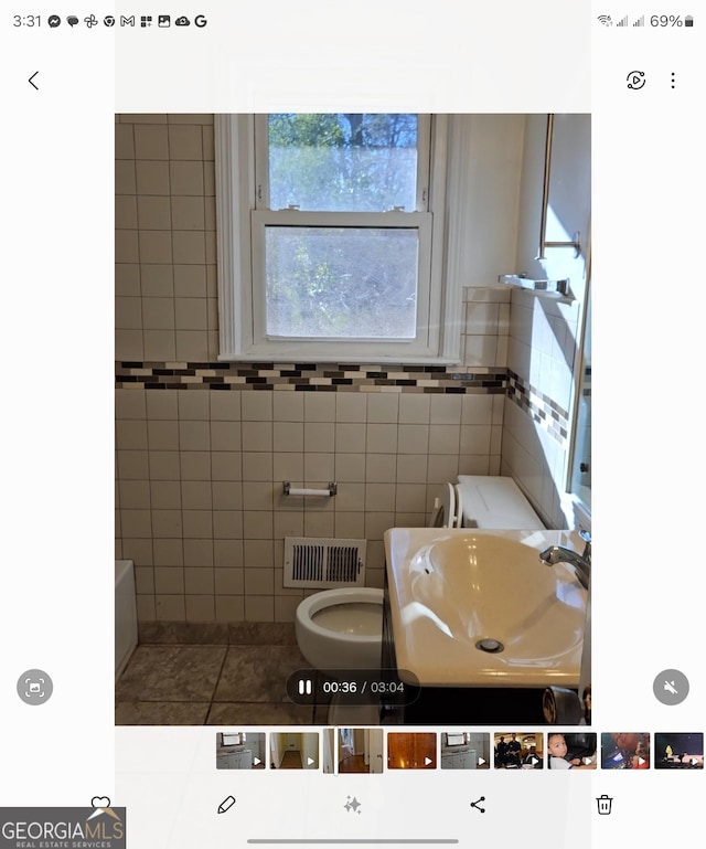 bathroom featuring sink, tile patterned floors, and toilet