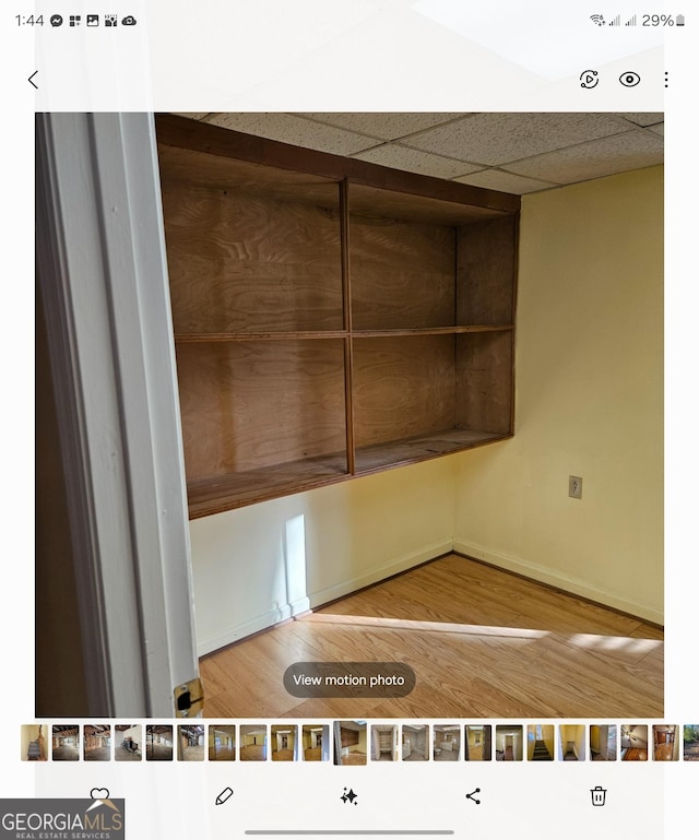 interior space featuring hardwood / wood-style floors and a paneled ceiling