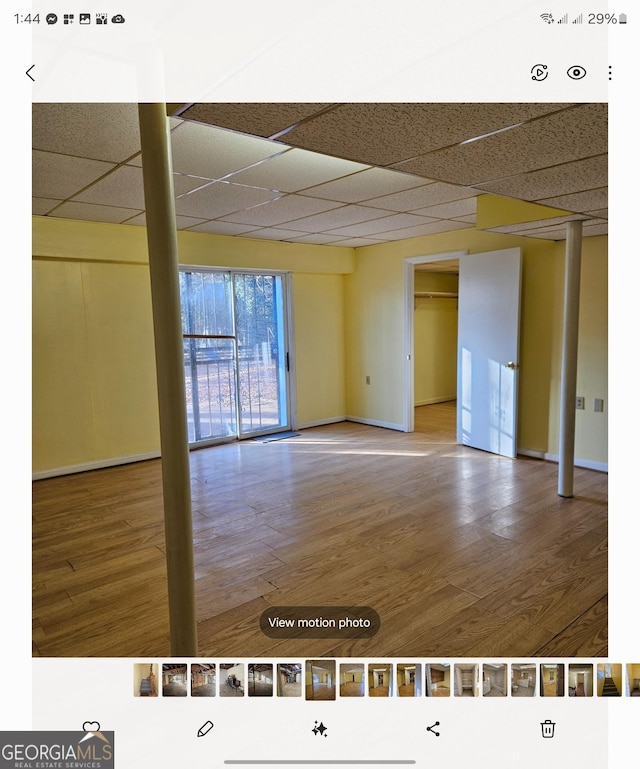 spare room featuring hardwood / wood-style floors and a paneled ceiling