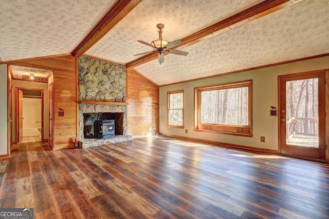 unfurnished living room featuring vaulted ceiling with beams, ornamental molding, hardwood / wood-style floors, and a textured ceiling