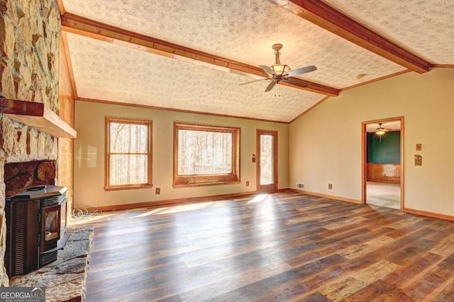 unfurnished living room featuring hardwood / wood-style flooring, ornamental molding, lofted ceiling with beams, and a wood stove