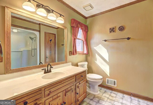 bathroom featuring walk in shower, vanity, crown molding, and toilet