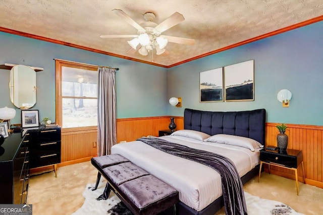 bedroom with ceiling fan, carpet flooring, ornamental molding, a textured ceiling, and wood walls