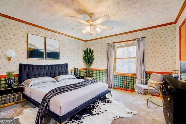 carpeted bedroom featuring ceiling fan, crown molding, and a textured ceiling