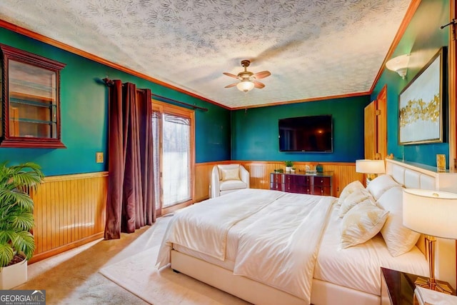 bedroom featuring ceiling fan, crown molding, carpet floors, and a textured ceiling