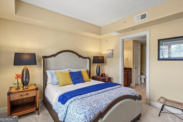 carpeted bedroom featuring connected bathroom