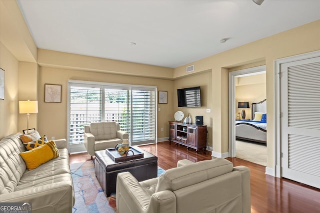 living room with dark hardwood / wood-style flooring