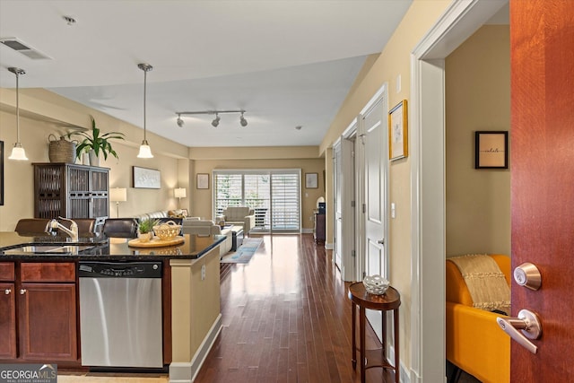 kitchen with dark hardwood / wood-style floors, dishwasher, sink, a breakfast bar area, and hanging light fixtures