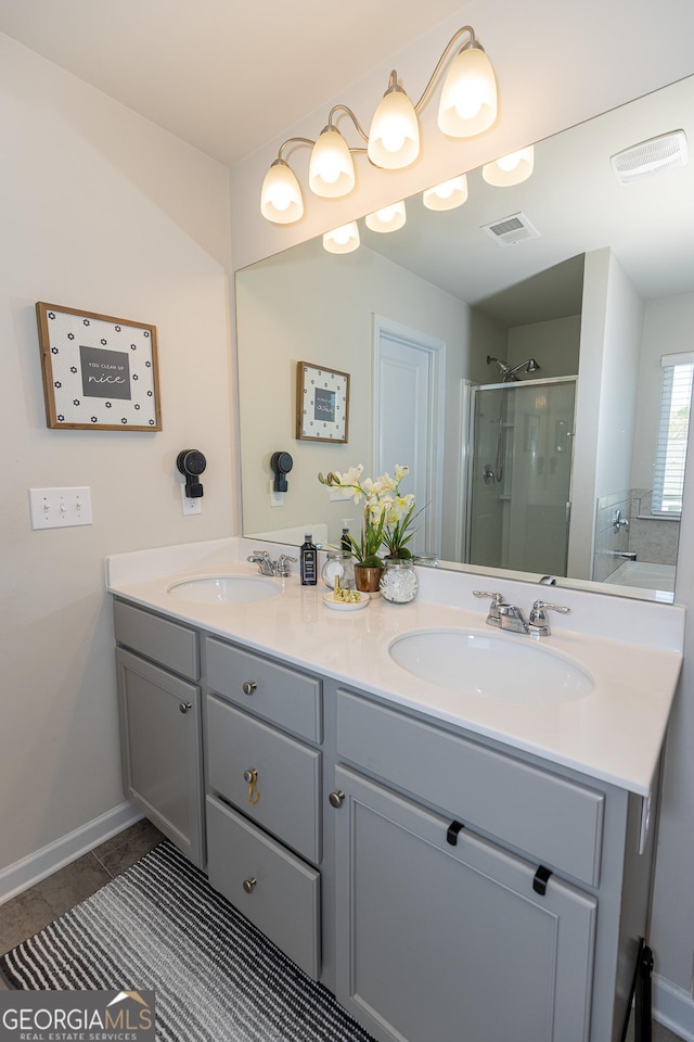 bathroom featuring vanity, shower with separate bathtub, and tile patterned floors