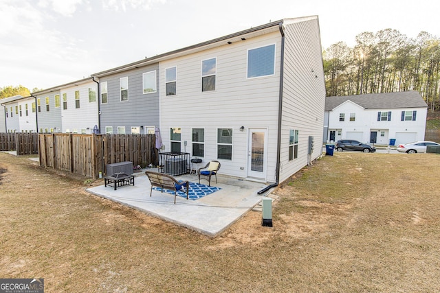 rear view of property with a yard and a patio area