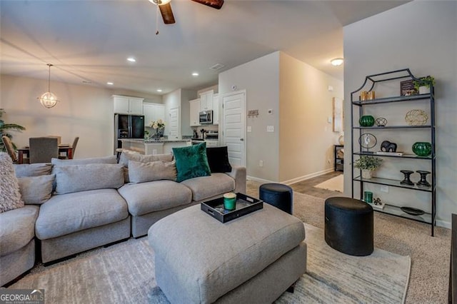 living room with light colored carpet and ceiling fan