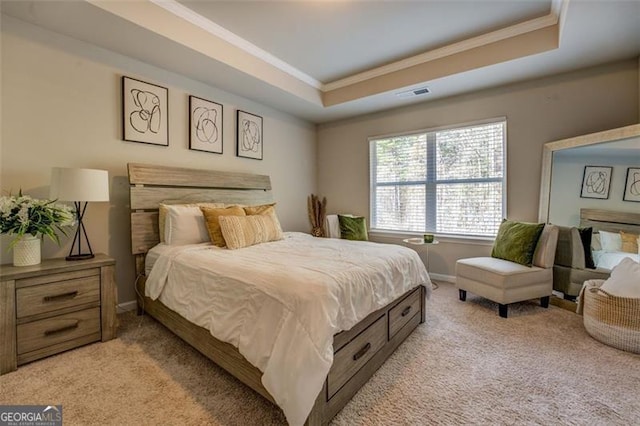 bedroom featuring a raised ceiling, crown molding, and light colored carpet