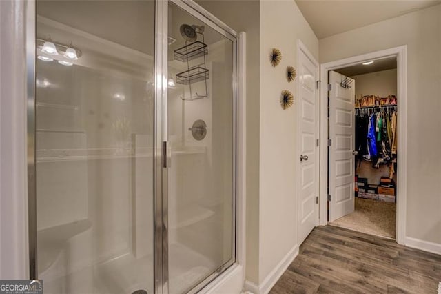 bathroom with wood-type flooring and walk in shower