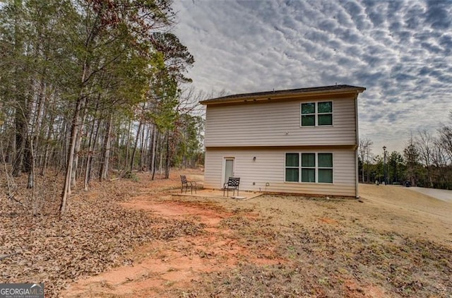 rear view of property featuring a patio area