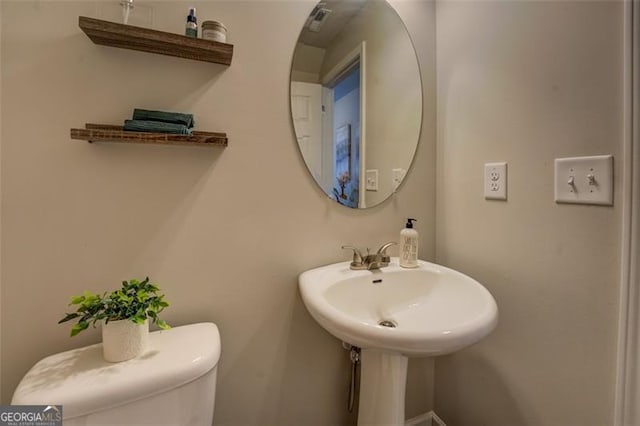 bathroom featuring sink and toilet