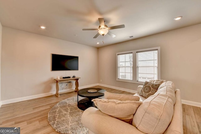 living room featuring ceiling fan and light hardwood / wood-style floors