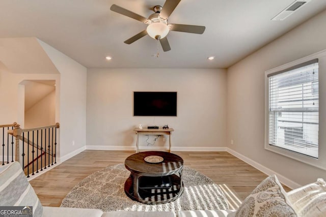 living room featuring ceiling fan and light wood-type flooring