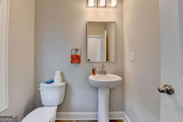 bathroom featuring sink and toilet