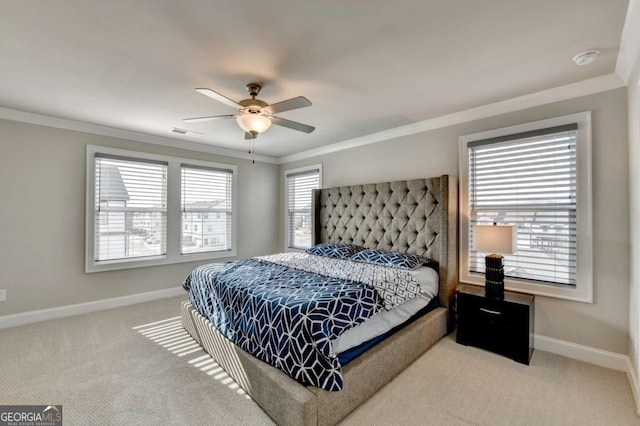 carpeted bedroom with ceiling fan and ornamental molding