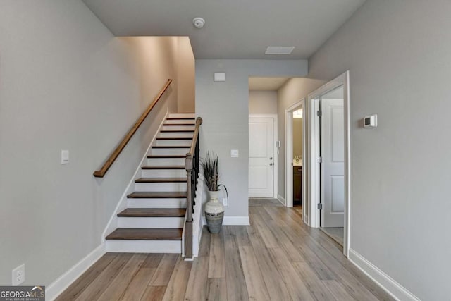 staircase featuring wood-type flooring