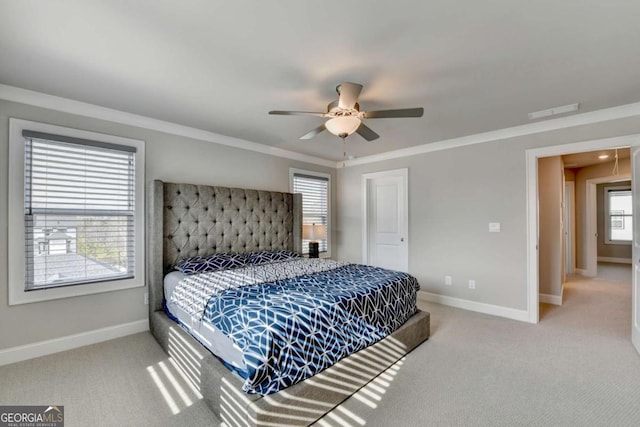 bedroom with crown molding, ceiling fan, and carpet flooring