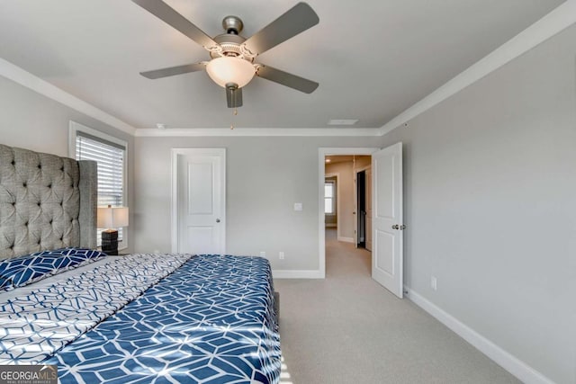 carpeted bedroom with ceiling fan and ornamental molding