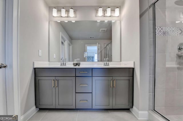 bathroom with tile patterned floors, a shower with shower door, and vanity