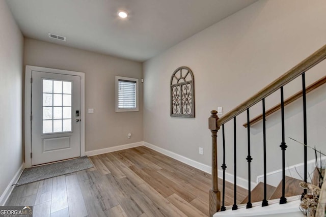 foyer entrance with light hardwood / wood-style floors