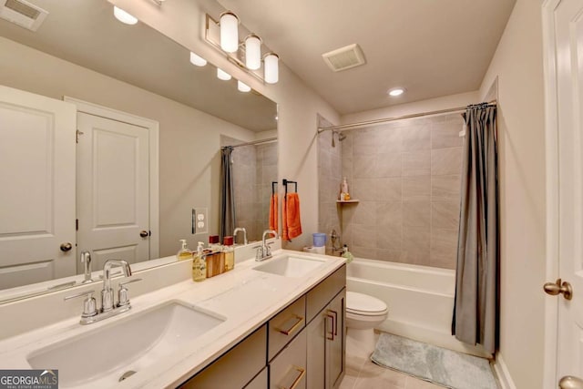 full bathroom featuring shower / tub combo, vanity, tile patterned floors, and toilet