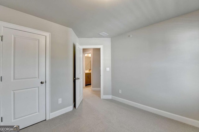 unfurnished bedroom featuring light colored carpet