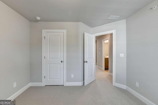 unfurnished bedroom featuring light colored carpet