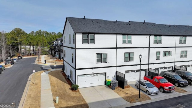 rear view of property featuring a garage