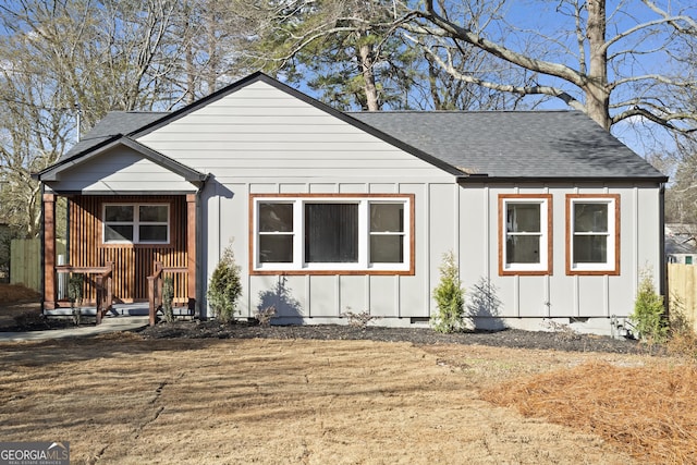 view of front of house featuring crawl space, board and batten siding, and a shingled roof