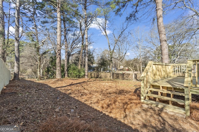 view of yard with fence and a wooden deck