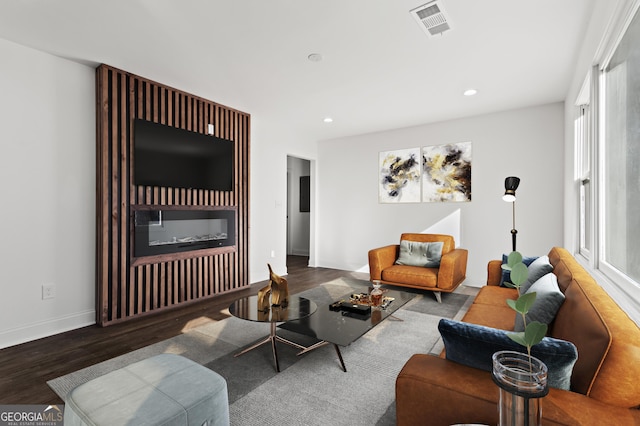 living room with recessed lighting, wood finished floors, visible vents, and baseboards