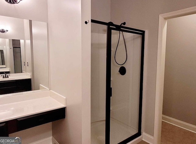 bathroom with vanity and a shower with shower door