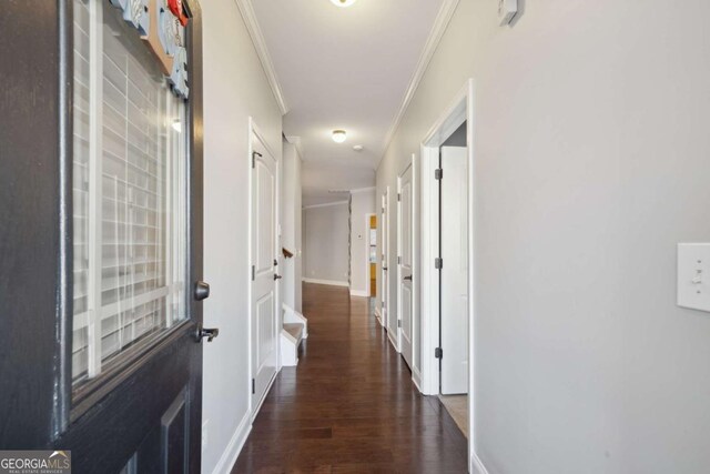 corridor with dark hardwood / wood-style flooring and crown molding